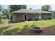 Spacious backyard with a stone patio, lush lawn, fire pit, and a privacy fence at 2126 Dawnshire Dr, Columbus, IN 47203