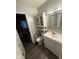 Bathroom with white vanity, mirror, and toilet with handicap assistance at 2126 Dawnshire Dr, Columbus, IN 47203