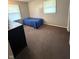 A bedroom with carpeting, a blue bed, and a window at 2126 Dawnshire Dr, Columbus, IN 47203