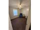 Cozy bedroom featuring a ceiling fan, plush carpet, and a comfortable recliner chair, bathed in soft light at 2126 Dawnshire Dr, Columbus, IN 47203