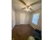 Comfortable bedroom with plush carpet, a ceiling fan, and a cozy recliner chair near the window at 2126 Dawnshire Dr, Columbus, IN 47203