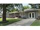 Charming home featuring a brick facade, gray siding, a well-manicured lawn, and mature trees at 2126 Dawnshire Dr, Columbus, IN 47203
