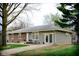 Charming single-story home featuring a brick facade, well-maintained lawn, and inviting front porch with seating at 2126 Dawnshire Dr, Columbus, IN 47203