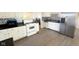 Bright kitchen features white cabinets, sleek black countertops, and stainless steel refrigerator at 2126 Dawnshire Dr, Columbus, IN 47203