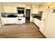Bright kitchen with white cabinets, laminate flooring, updated backsplash, and modern appliances at 2126 Dawnshire Dr, Columbus, IN 47203