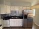 Well-lit kitchen featuring white cabinetry, sleek stainless steel refrigerator, and modern tile backsplash at 2126 Dawnshire Dr, Columbus, IN 47203
