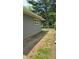 Side yard with a gravel path and a gate, offering convenient access to the property at 2126 Dawnshire Dr, Columbus, IN 47203