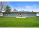 Well-maintained backyard with green grass and patio area perfect for outdoor relaxation and entertainment at 2200 W Christy Ln, Muncie, IN 47304