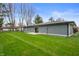 Spacious backyard featuring a well-manicured lawn and privacy from surrounding trees at 2200 W Christy Ln, Muncie, IN 47304