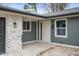 Close up shot of a home's entrance featuring a gray siding and a stone pillar at 2200 W Christy Ln, Muncie, IN 47304