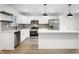 Modern kitchen with stainless steel appliances, white cabinetry, and an island with seating at 2200 W Christy Ln, Muncie, IN 47304