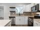 Updated kitchen with stainless steel appliances, a white countertop, and dark gray backsplash at 2200 W Christy Ln, Muncie, IN 47304
