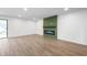 Bright living room with a modern electric fireplace and sliding glass door access to the outdoors at 2200 W Christy Ln, Muncie, IN 47304