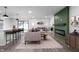 Open concept living room showcasing modern decor, fireplace, and breakfast bar at 2200 W Christy Ln, Muncie, IN 47304
