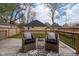 Back deck featuring wicker furniture, small side table, wooden perimeter railing, and exterior yard views at 2209 Carrollton Ave, Indianapolis, IN 46205