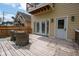 Back deck with seating area, overhead porch and exterior entrance at 2209 Carrollton Ave, Indianapolis, IN 46205