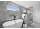 Modern bathroom with a standalone tub and tiled walls at 2209 Carrollton Ave, Indianapolis, IN 46205