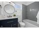 Modern bathroom features a vanity sink, toilet, and gray tiled shower with a glass shelf at 2209 Carrollton Ave, Indianapolis, IN 46205
