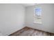 Bedroom features wood floor and window offering natural light at 2209 Carrollton Ave, Indianapolis, IN 46205