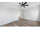Bedroom features wood floors, white walls, closet, ceiling fan, and interior door at 2209 Carrollton Ave, Indianapolis, IN 46205