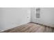 Clean bedroom with luxury vinyl plank flooring, white walls, and large window for ample natural light at 2209 Carrollton Ave, Indianapolis, IN 46205