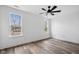 Bright bedroom with wood floors, modern ceiling fan, and natural light from the windows at 2209 Carrollton Ave, Indianapolis, IN 46205
