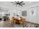 Bright dining room with wood table, modern art, ceiling fan, and luxury vinyl plank flooring at 2209 Carrollton Ave, Indianapolis, IN 46205