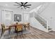 Dining room features a modern chandelier, wood table and luxury vinyl plank flooring at 2209 Carrollton Ave, Indianapolis, IN 46205