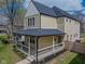 Inviting two-story home with a covered front porch and manicured lawn at 2209 Carrollton Ave, Indianapolis, IN 46205