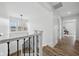 Bright hallway with wood floors, modern lighting, and white trim at 2209 Carrollton Ave, Indianapolis, IN 46205