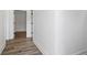 Hallway featuring luxury vinyl plank flooring, neutral walls, and modern door frames at 2209 Carrollton Ave, Indianapolis, IN 46205