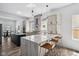 Modern kitchen with marble counters, stainless steel appliances, and a kitchen island at 2209 Carrollton Ave, Indianapolis, IN 46205