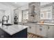 Stylish kitchen with tile backsplash, stainless steel hood, and modern cabinets at 2209 Carrollton Ave, Indianapolis, IN 46205