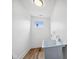 Bright laundry room with utility sink, window, and wood floor at 2209 Carrollton Ave, Indianapolis, IN 46205