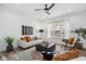 Bright living room featuring modern furniture, luxury vinyl plank flooring, and ample sunlight at 2209 Carrollton Ave, Indianapolis, IN 46205