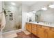 Bright bathroom with double vanity, walk-in shower, and neutral tones at 225 N New Jersey St # Apt 48, Indianapolis, IN 46204