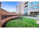 Stylish building entrance with manicured greenery and brick signage at 225 N New Jersey St # Apt 48, Indianapolis, IN 46204