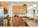 Bright kitchen with wood cabinets, stone countertops and modern appliances at 225 N New Jersey St # Apt 48, Indianapolis, IN 46204