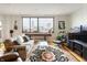 Cozy living room with a large window offering cityscape views and comfortable seating at 225 N New Jersey St # Apt 48, Indianapolis, IN 46204