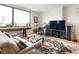 Inviting living room with cityscape views, a large window, and stylish furnishings at 225 N New Jersey St # Apt 48, Indianapolis, IN 46204