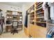 Organized walk-in closet featuring custom shelving, storage, and a desk at 225 N New Jersey St # Apt 48, Indianapolis, IN 46204