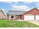 Charming brick home with an attached two-car garage and well-maintained front lawn at 229 Waterford Ct, Avon, IN 46123