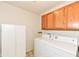 Efficient laundry room with washer, dryer, storage cabinet, and ample upper cabinet storage at 229 Waterford Ct, Avon, IN 46123