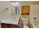 Bathroom featuring a shower-tub combo, wooden cabinets and neutral wall color at 2606 Bristlecone Dr, Indianapolis, IN 46217