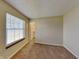 Neutral bedroom with tan carpet, a window with blinds, and a closet with door at 2606 Bristlecone Dr, Indianapolis, IN 46217