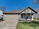 Charming single-story home with a covered porch and attached two-car garage at 2606 Bristlecone Dr, Indianapolis, IN 46217