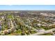 Expansive aerial view shows a residential neighborhood with tree-lined streets and homes and nearby commercial area at 2753 N High School Rd, Indianapolis, IN 46224