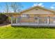 View of a backyard deck with gray railings and green grass beyond at 2753 N High School Rd, Indianapolis, IN 46224