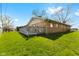 Lush backyard featuring green lawn and a wooden deck with gray railings at 2753 N High School Rd, Indianapolis, IN 46224