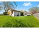 Spacious backyard with green grass, partial fence, and an outbuilding at 2753 N High School Rd, Indianapolis, IN 46224